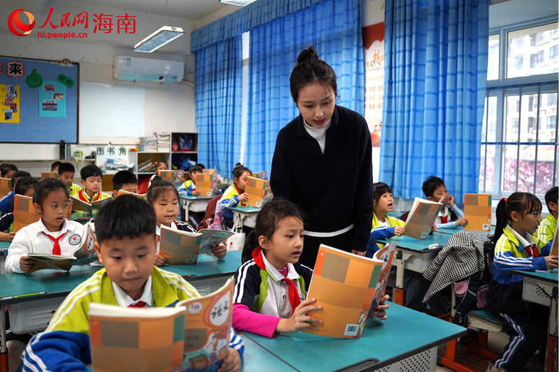 王芮輔導(dǎo)學(xué)生讀課文。 人民網(wǎng)記者 孟凡盛攝.JPG