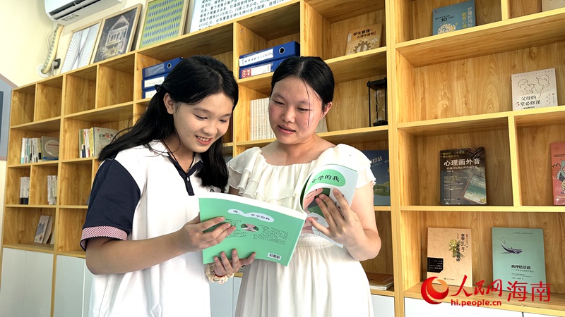 老師和學(xué)生一起閱讀書籍。人民網(wǎng)記者 符武平攝
